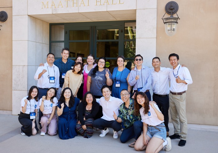 SUA alumni and educators pose outside Maathai Hall during the SIGS Education Conference