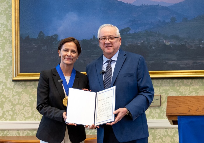 Dr. Mirian Vilela poses with President Ed Feasel as she accepts the 2024 Soka Global Citizen Award