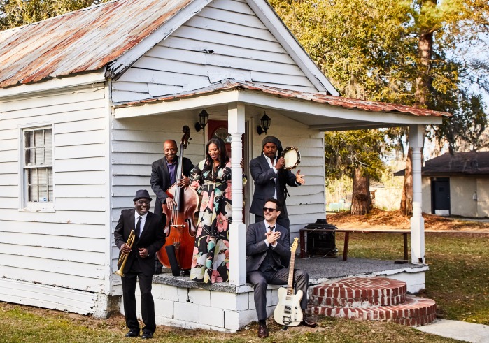 Artists sitting on porch of house