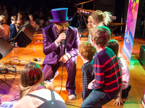 Secret Agent 23 Skidoo performing on stage with kids