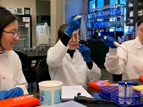 Three students working in science lab