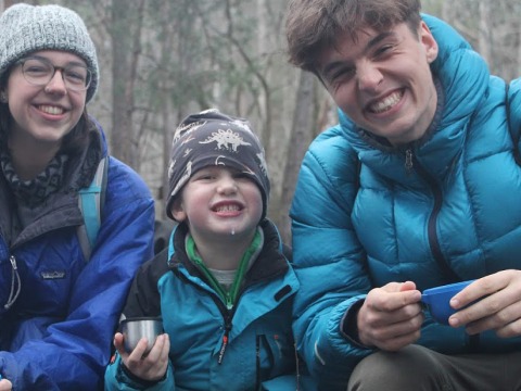 Students with young boy at a nature school