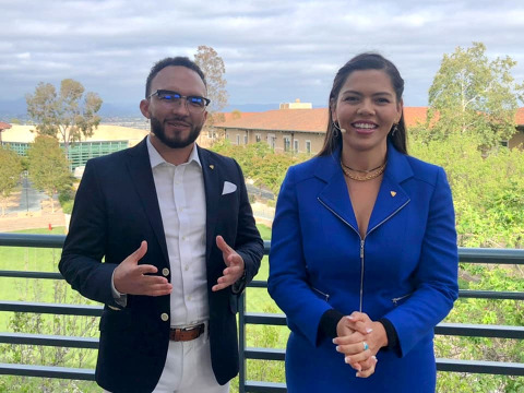 Hosts Zane Romano and Corina Giselle on a balcony overlooking campus