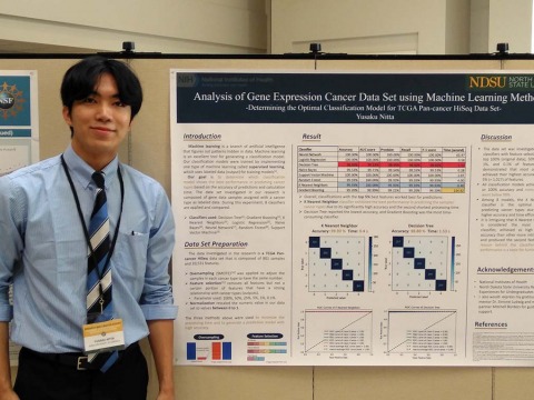 Person stands next to machine learning methods poster