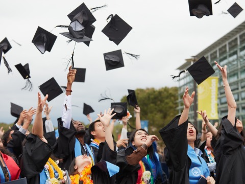 Soka's Class of 2023 throws their graduation caps in the air in celebration