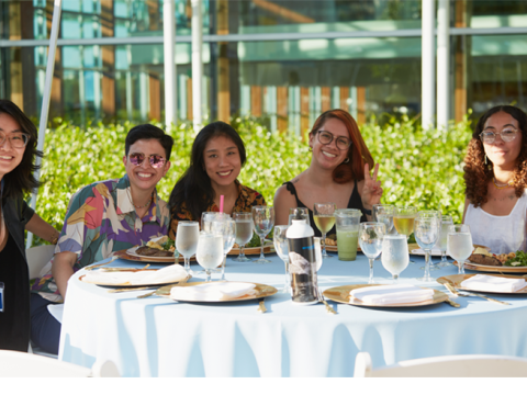 Members of the Class of 2013 pose at a table during their 10th reunion.