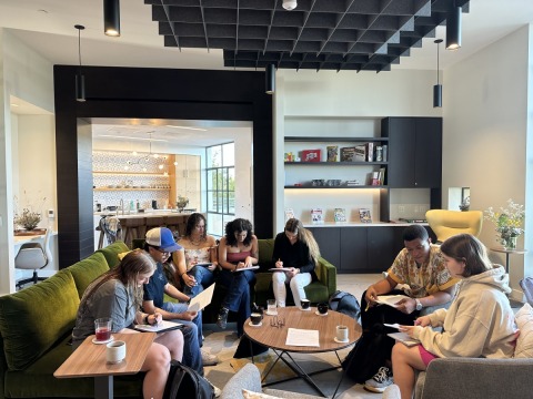 A large group of students sit together in the Global Language and Culture Center