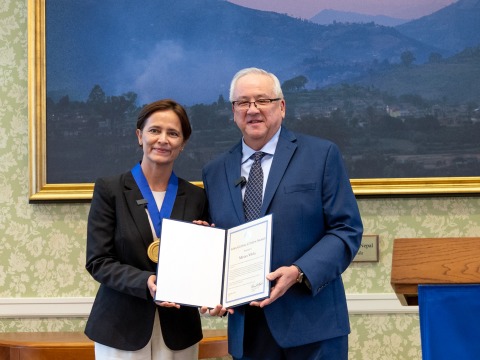 Dr. Mirian Vilela poses with President Ed Feasel as she accepts the 2024 Soka Global Citizen Award