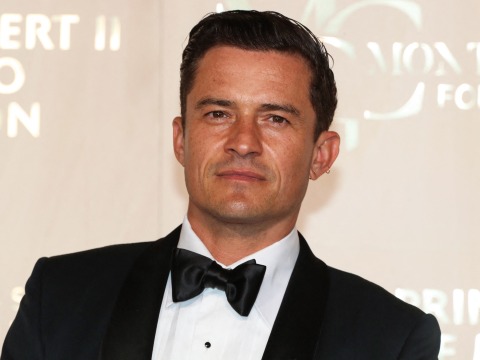 Orlando Bloom poses in a tuxedo at an event. Photo by Valery Hache/AFP via Getty Images