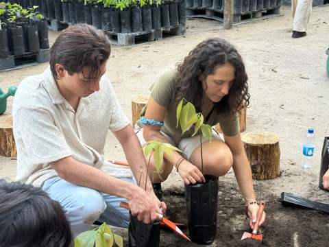 Two students dig with shovels during a native plant species workshop.
