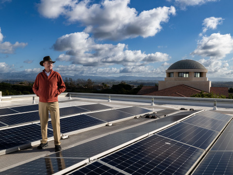 Professor George Busenberg observing the solar panels on the roof 