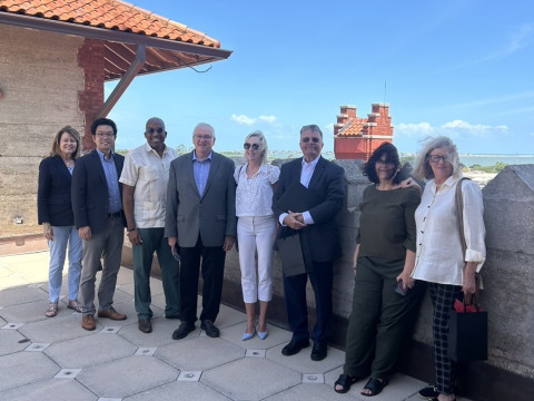 Men and women representing Soka University of America and the Hazel Henderson Center pose for a photo on a rooftop.