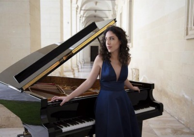 Beatrice Rana standing at piano