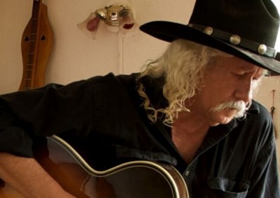 Arlo Guthrie playing guitar