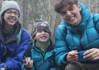 Students with young boy at a nature school