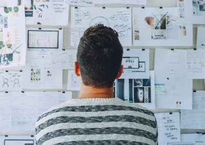 Man viewing charts on wall