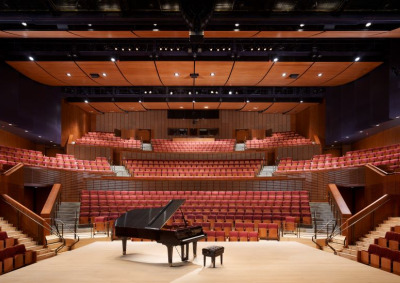 Interior of Concert Hall with piano and bench center stage