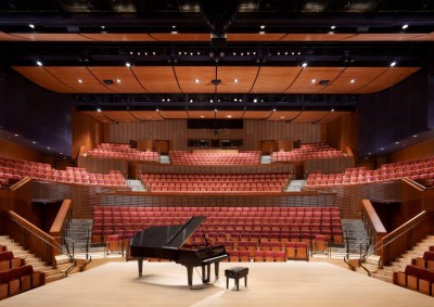 Interior of Concert Hall with piano and bench center stage
