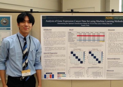 Person stands next to machine learning methods poster