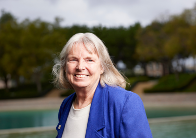 Wendy Harder smiles as she stands in front of Peace Lake