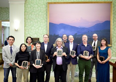 11 Faculty Members pose with their Merit Awards