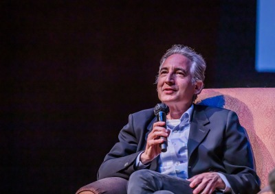 Physicist Brian Greene speaks into the microphone