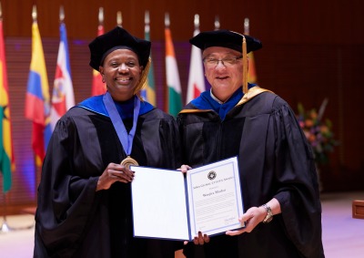 Wanjira Mathai smiles with President Feasel as she accepts the Soka Global Citizen Award