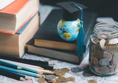 Earth globe with graduation hat sitting on books