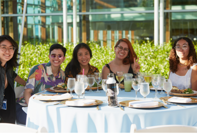 Members of the Class of 2013 pose at a table during their 10th reunion.