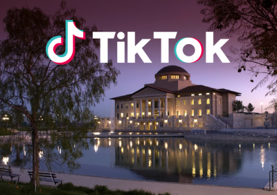 TikTok logo is pictured above Peace Lake and Founders Hall at dusk