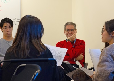 Dr. Bartoli rests his hand on his chin as he listens in during a class at Soka University of America