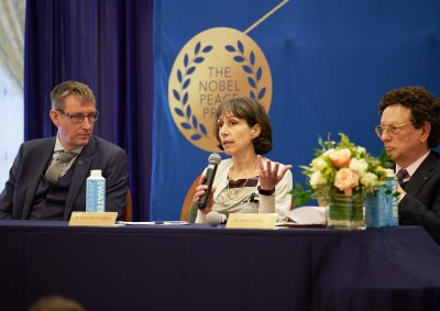 Dr. Asle Toje listens to Dr. Ivana Nikolić Hughes speak as Dr. William Potter looks on during the Nobel Seminars