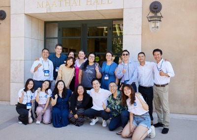 SUA alumni and educators pose outside Maathai Hall during the SIGS Education Conference