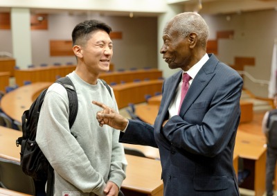 Dr. Lawrence E. Carter, Sr. shares a laugh with a student after his speech at SUA