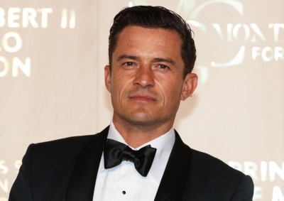 Orlando Bloom poses in a tuxedo at an event. Photo by Valery Hache/AFP via Getty Images