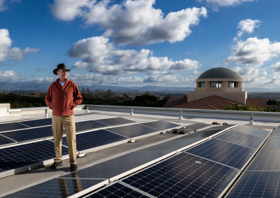 Professor George Busenberg observing the solar panels on the roof 