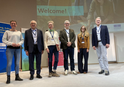 SUA President Ed Feasel (second from left) stands with international delegates on stage at the UNESCO "Charting New Horizons for Education for Sustainable Development" conference in Hanover, Germany.
