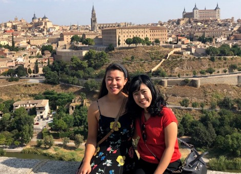 Two students in front of cityscape in Valencia, Spain