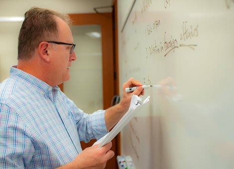 Peter Burns writes on a whiteboard