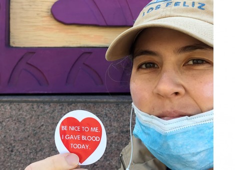 Victoria Kraus holding an "I gave blood today" sticker