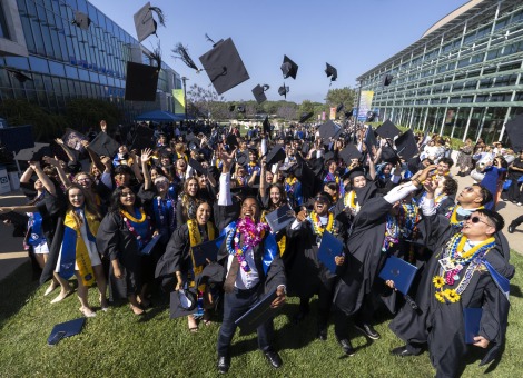Students throwing graduation caps.