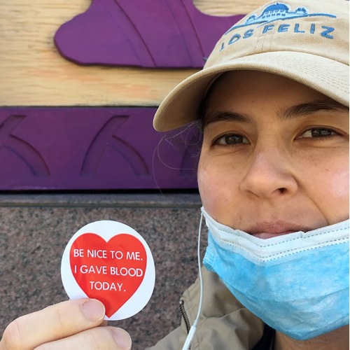 Victoria Kraus holding an "I gave blood today" sticker