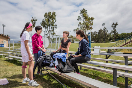 Image of students chatting by the track.