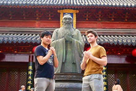 Two students with statue in Shanghai