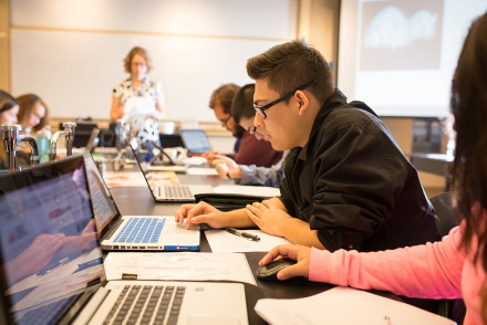 Students working on laptops in Pauling Hall classroom