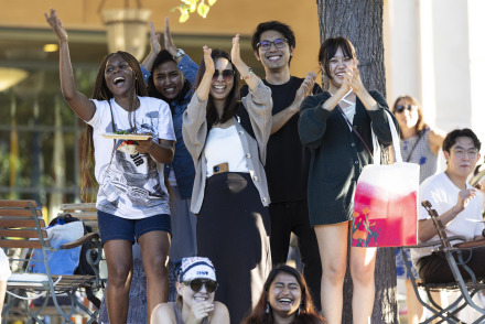 Students applaud during a welcome back event on SUA's campus.