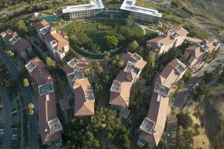 Aerial view of exterior of multiple residence halls and a grassy area in between them.