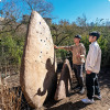 Students looking at a large boulder in the desert