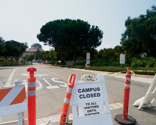 Campus closed barrier at Soka entrance with Founders Hall in the background