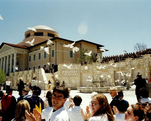 Students congregate in plaza as doves fly